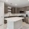 Photo of Aventon Soraya's kitchens with brown slab cabinets, white quartz countertops and subway tile backsplash