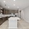 Photo of Aventon Soraya's kitchens with brown slab cabinets, white quartz countertops and subway tile backsplash